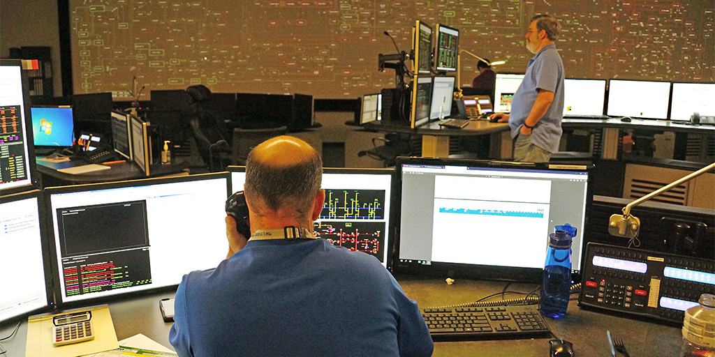 Operator Jeff Mullen phones a (mock) utility operator to recalibrate power generation during a simulation of a line loss.