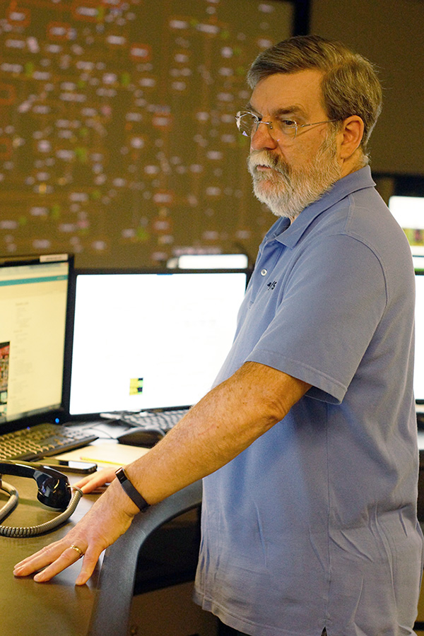 Kenneth Lizke, shift supervisor of the Control Room, looks at multiple screens of information during a recent day at NYISO's Control Room Simultor.